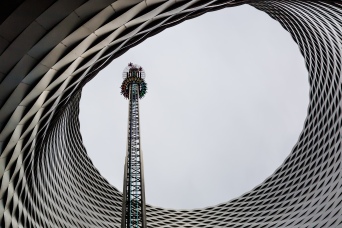 All the fun of the fair: A view of the Basel autumn fair with a free fall tower positioned in the exhibition centre hole "Fenster zum Himmel" ("window to heaven").